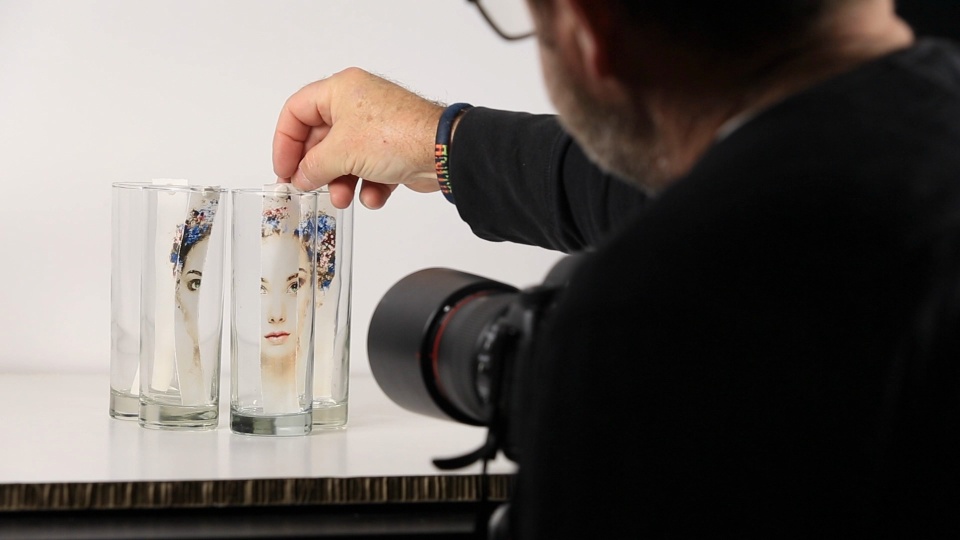 Martin Osner photographing a torn print through drinking glasses