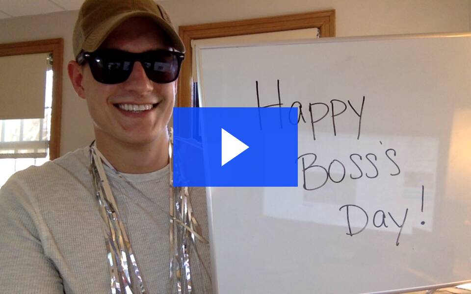 Wista video imbed screenshot with a person holding a whiteboard that says Happy Boss Day