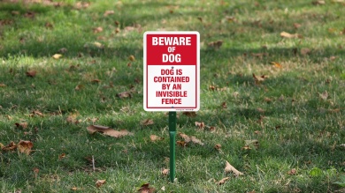 Dog Is Contained By An Invisible Fence LawnBoss Sign