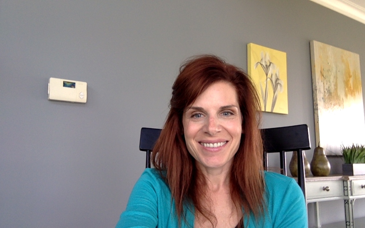 Dr. Ellen Antoine in a chair smiling