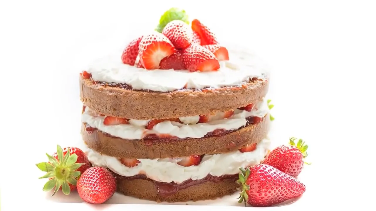 A delicious looking chocolate, strawberry and whipped cream cake.