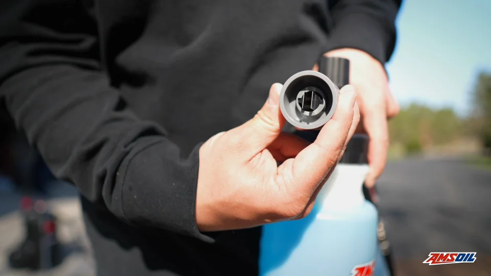 Hands Holding an AMSOIL Car Care Foam Cannon