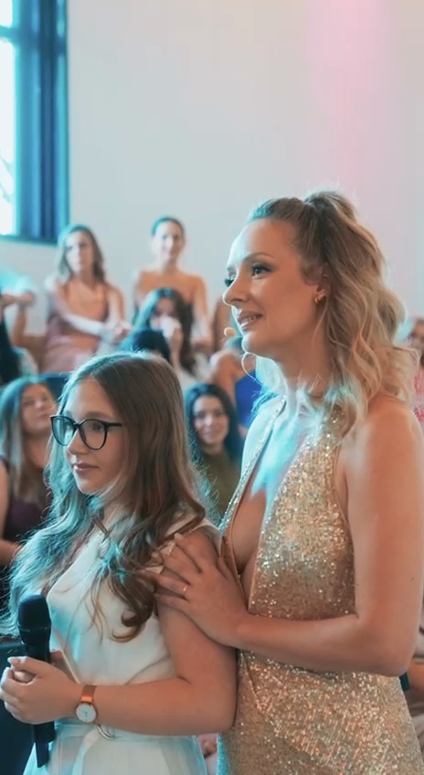 Still from the event Reel: two women in front of the audience at a live event