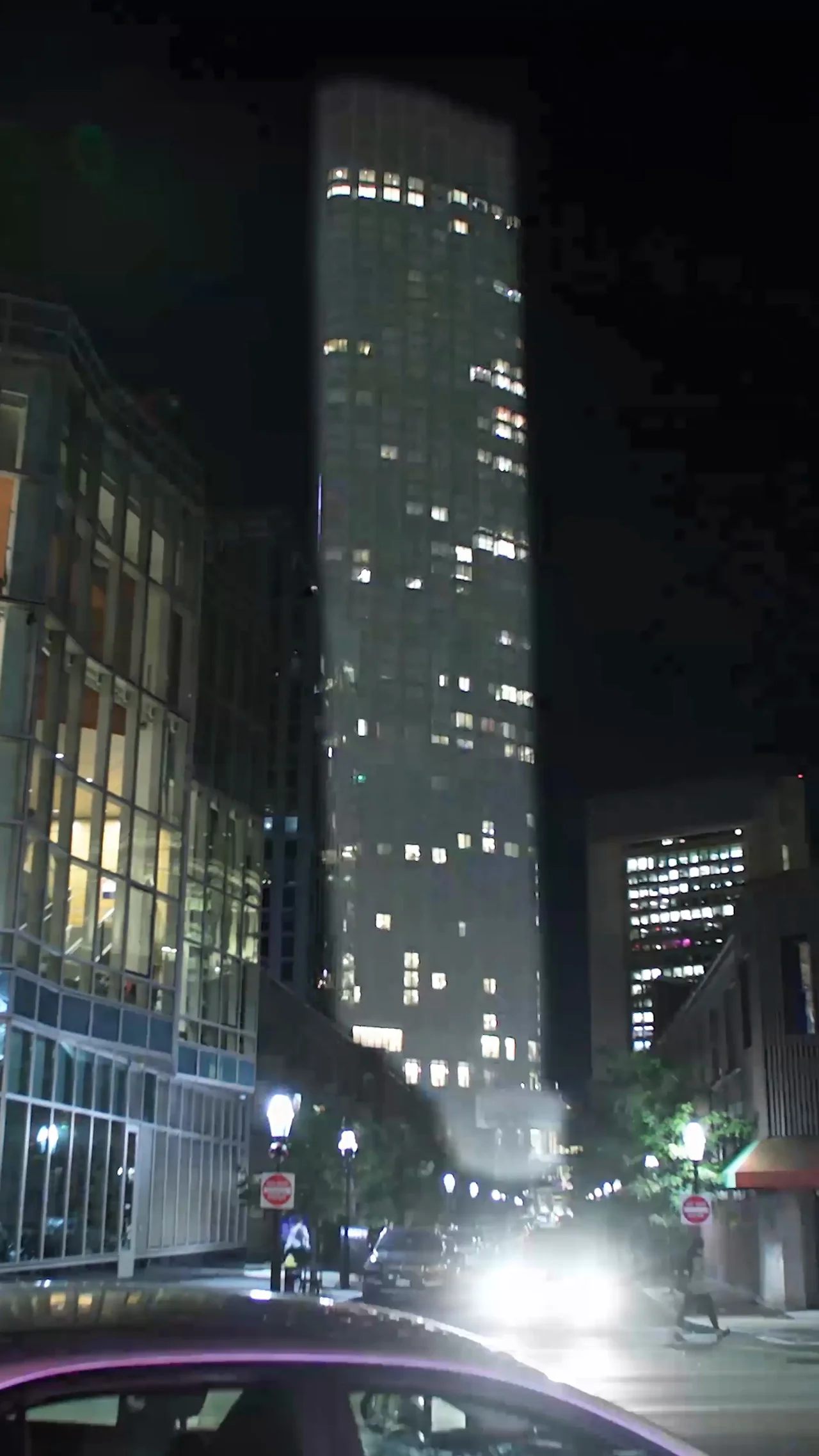 Man sitting beside glass window near high rise building photo