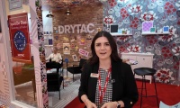 Amanda Lowe from Drytac demonstrates SpotOn Duo Mounting Adhesive at FESPA Berlin 2025