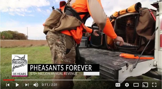 A screenshot from the testimonial video, shows a man at the back a pickup truck near a wildlife area